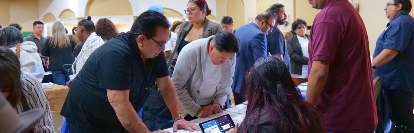 No Degree Required Hiring Event Photo of Job Seekers at Employer Tables